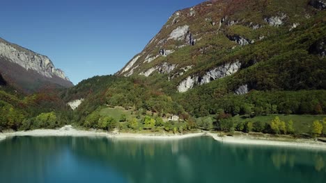 mountain blue water lake in italian alps dolomites with trees and peaks drone aerial