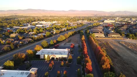 Drone-video-of-cars-driving-on-highway-surrounded-by-fall-trees