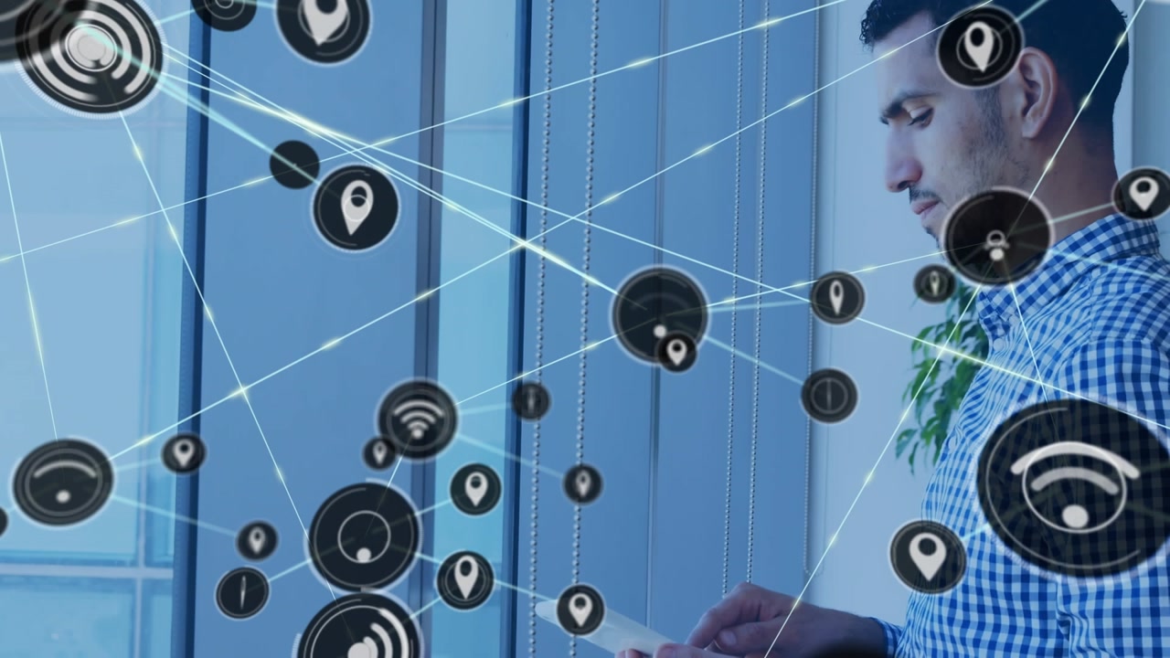 Animation of connected wifi and location icons over man using digital tablet in office