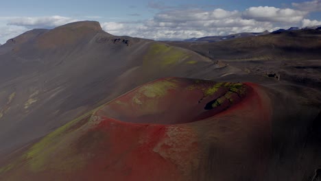 red volcanic craters of raudaskal mountains in the highlands of iceland, panning drone shot