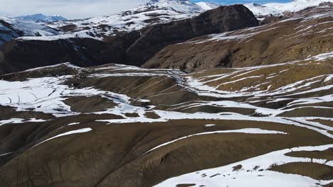 aerial-view-of-Langza-Buddha-Statue-in-kaza-spiti-valley-drone-revealing-scenic-mountains-landscape