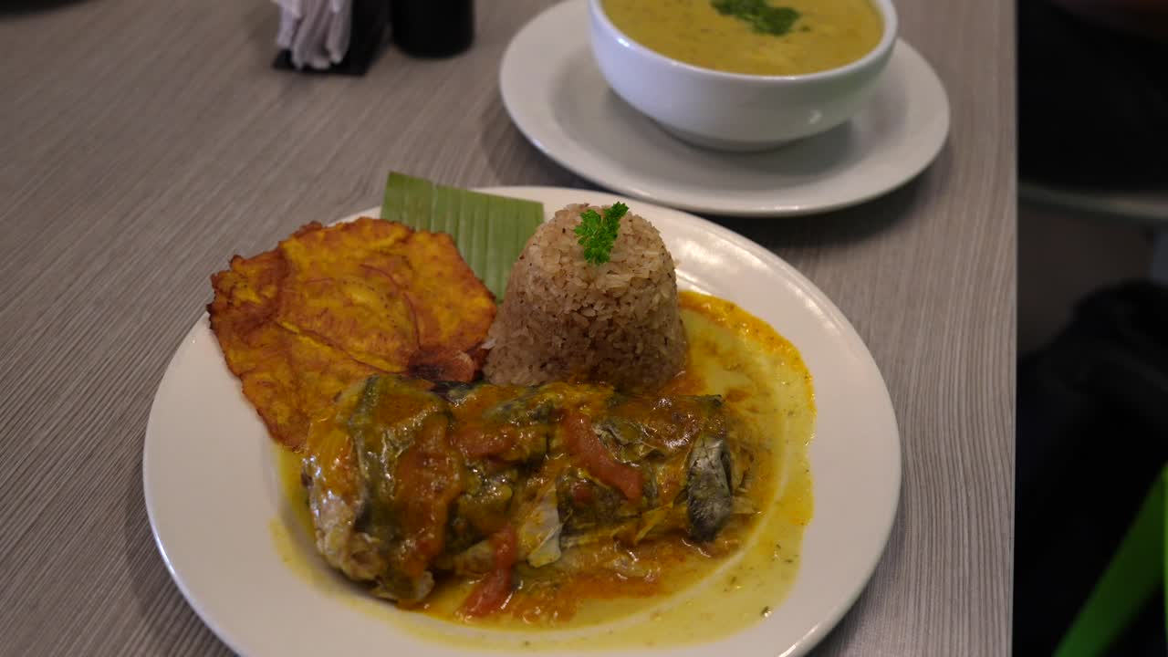Delicious Peruvian or Ecuadorian Fish Dish with Rice, Patacones, and Soup