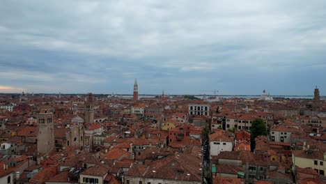 Italian-Venice-and-its-red-tile-roofs-at-sunrise,-birds-flying