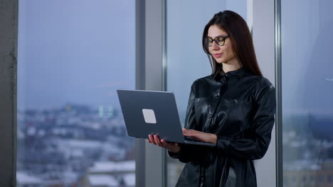 woman working on laptop at window