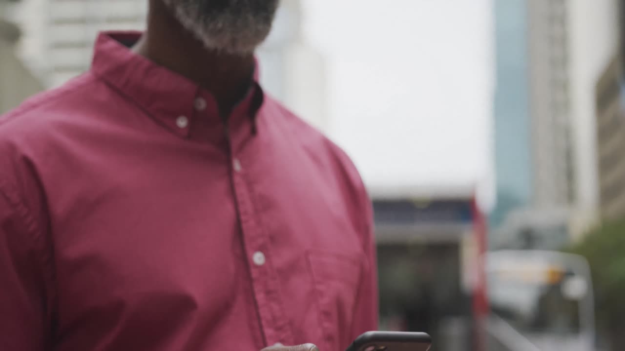African American man using his phone in the street