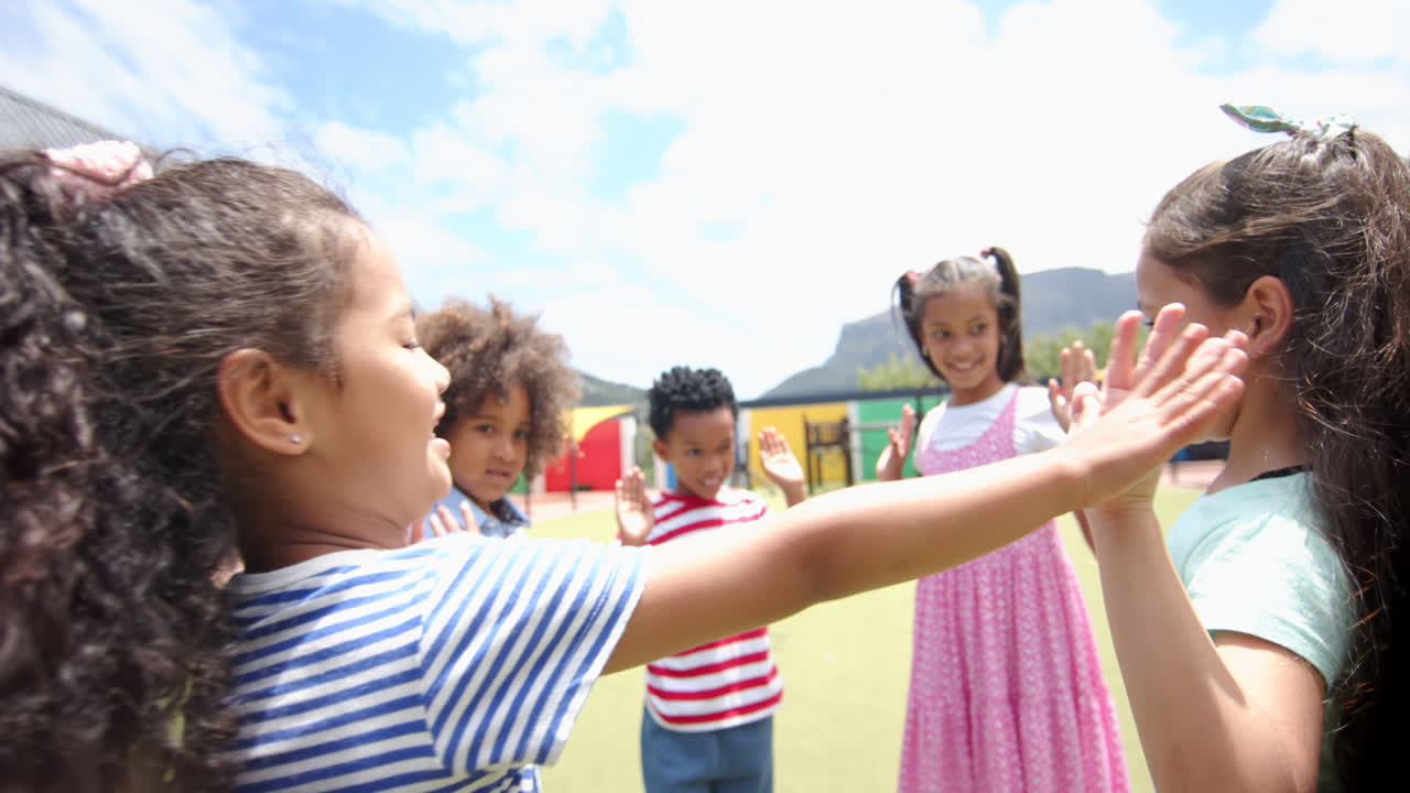 Playing together outside, group of school children enjoying recess activities
