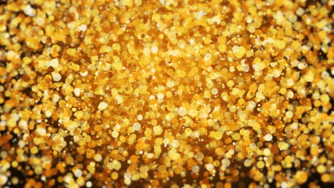 gorgeous sparkling golden buzzer shining confetti bokeh holiday loop background. shining stars confetti scatter.