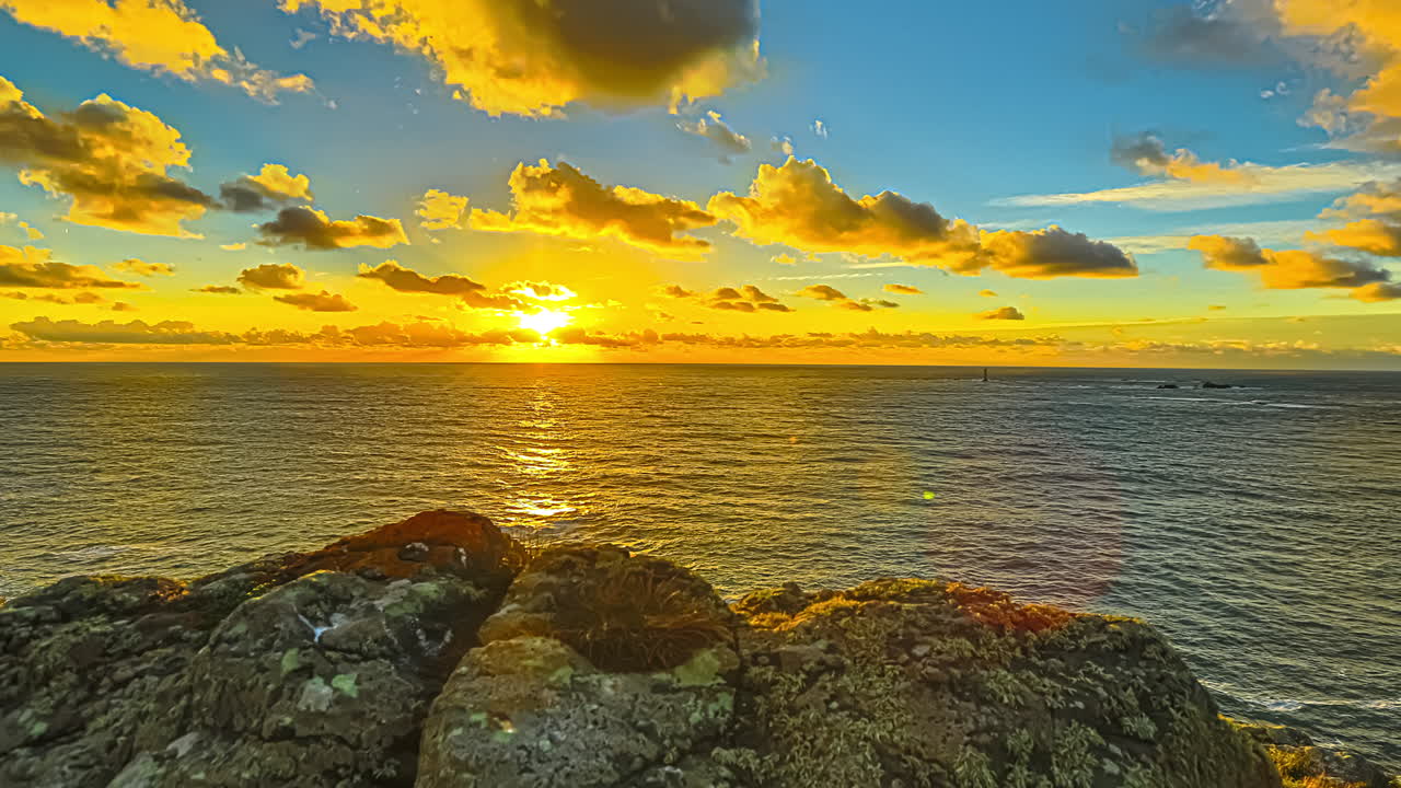 magic colored sky at sunset hour on the ocean in Guernsey island, coast of Normandy. Hyperlapse