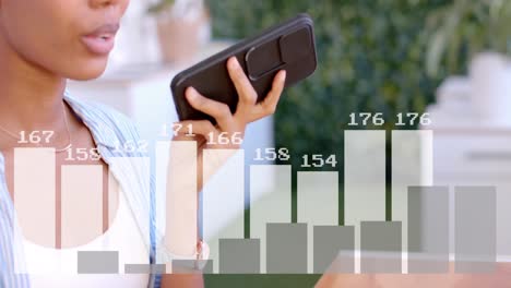 animation of data processing over biracial businesswoman using smartphone in office