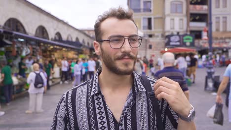 young man walking down the street in slow motion.