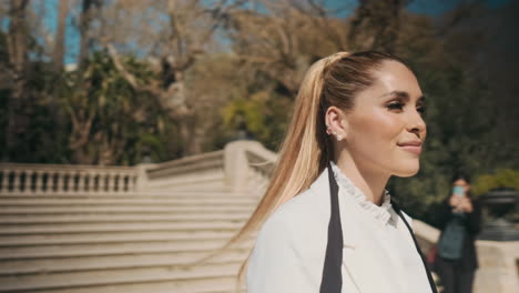 stylish young woman walking in the park outdoors.