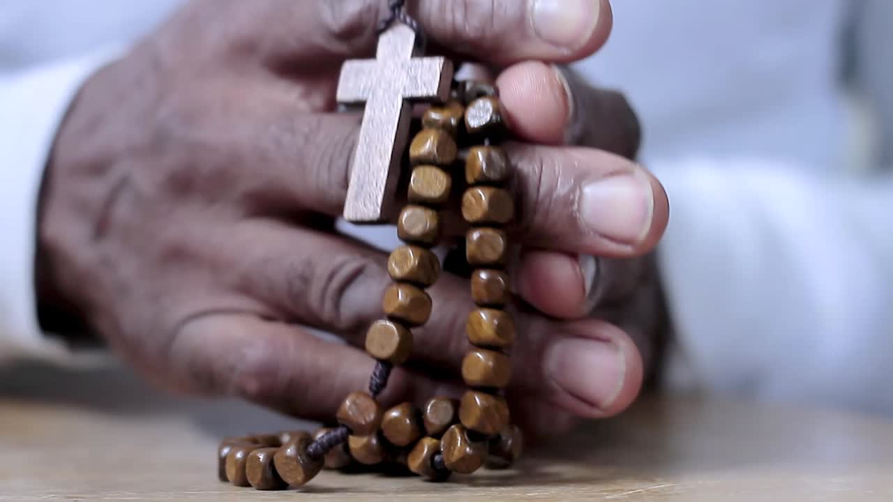 hombre rezando a dios con cruz en las manos hombre caribeño rezando con fondo blanco metrajes