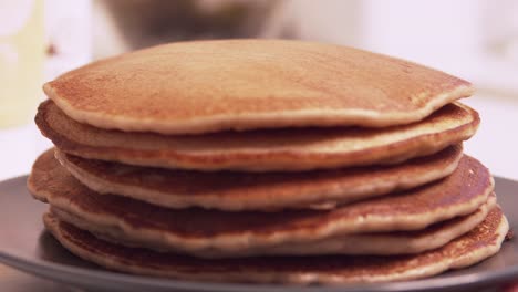 Delicious-pancakes-sliding-to-the-front-of-the-camera-on-the-table