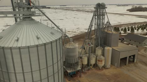 Drone-shot-of-a-grain-bin-in-Minnesota-during-the-winter-with-snow