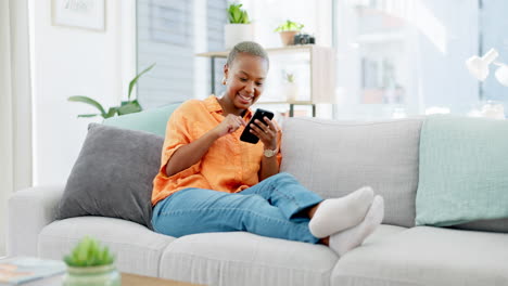 mujer negra, mensajes de texto y teléfono en el sofá para la diversión