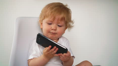 toddler-blonde-tries-to-take-huge-smartphone