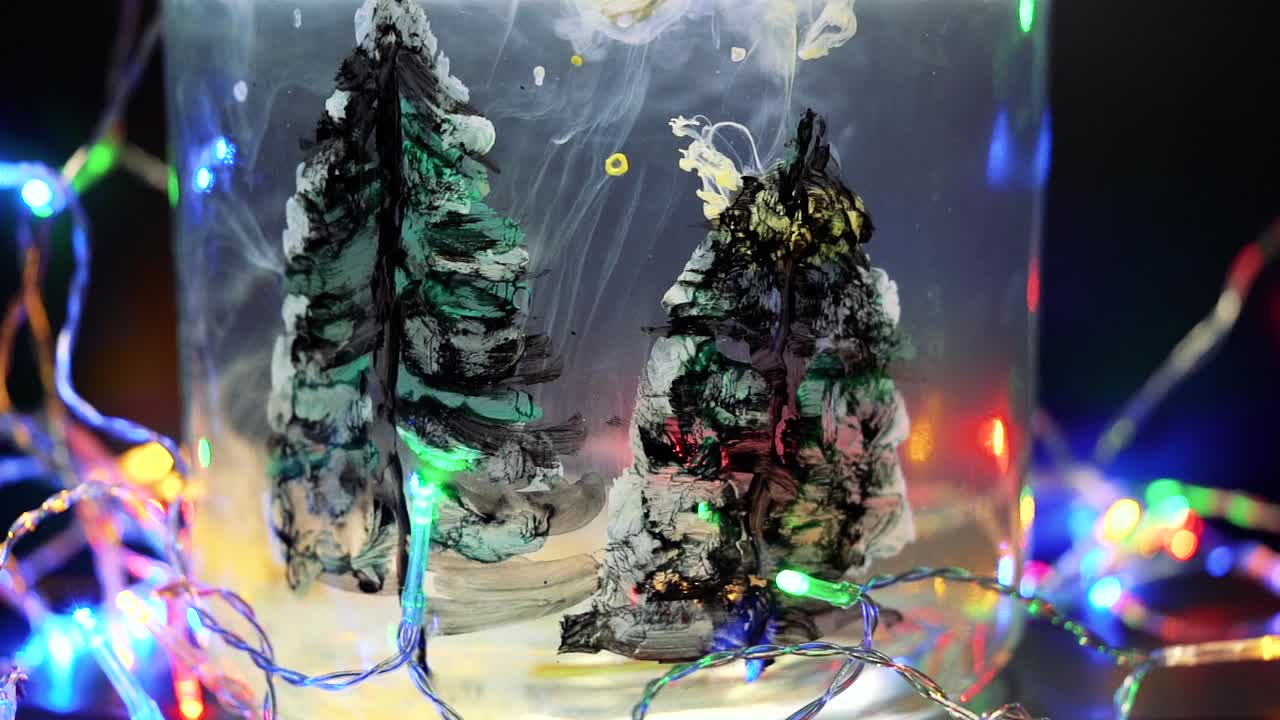 Colored paint floating in water tank surrounded by Christmas lights. Stable shot with the Sony a7iii