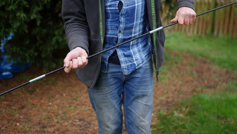 a mature man assembling tent poles together