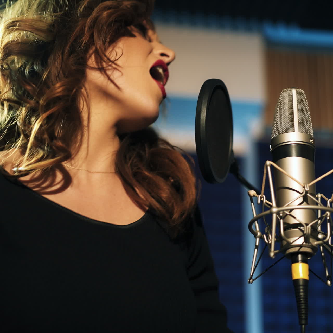 Beautiful young singer who recorded a song in a professional recording studio. Female vocal