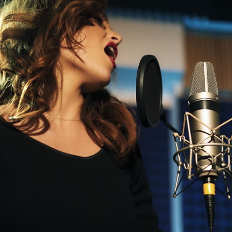 beautiful young singer who recorded a song in a professional recording studio. female vocal