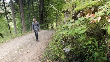 man walking through pokljuka gorge in slovenia during spring in the triglav national park