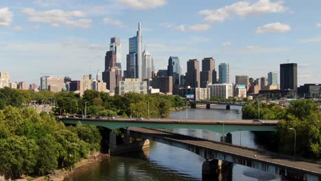 descending aerial drone shot above schuylkill river looking toward philadelphia pennsylvania city skyline