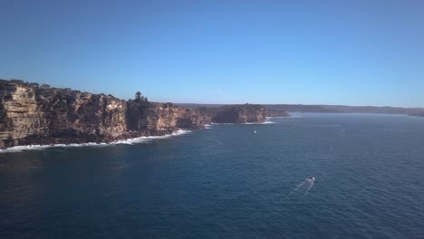 drone footage of towering ocean cliffs in sydney australia