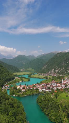 aerial vertical summer establishing view of small town atmost na soči in slovenia with it's emerald soča rive