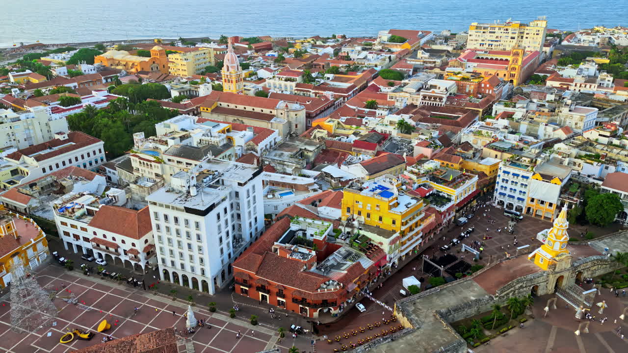 Aerial drone view of Cartagena's famous walled city, highlighting its colonial architecture, domed cathedral, and historic streets by the Caribbean Sea