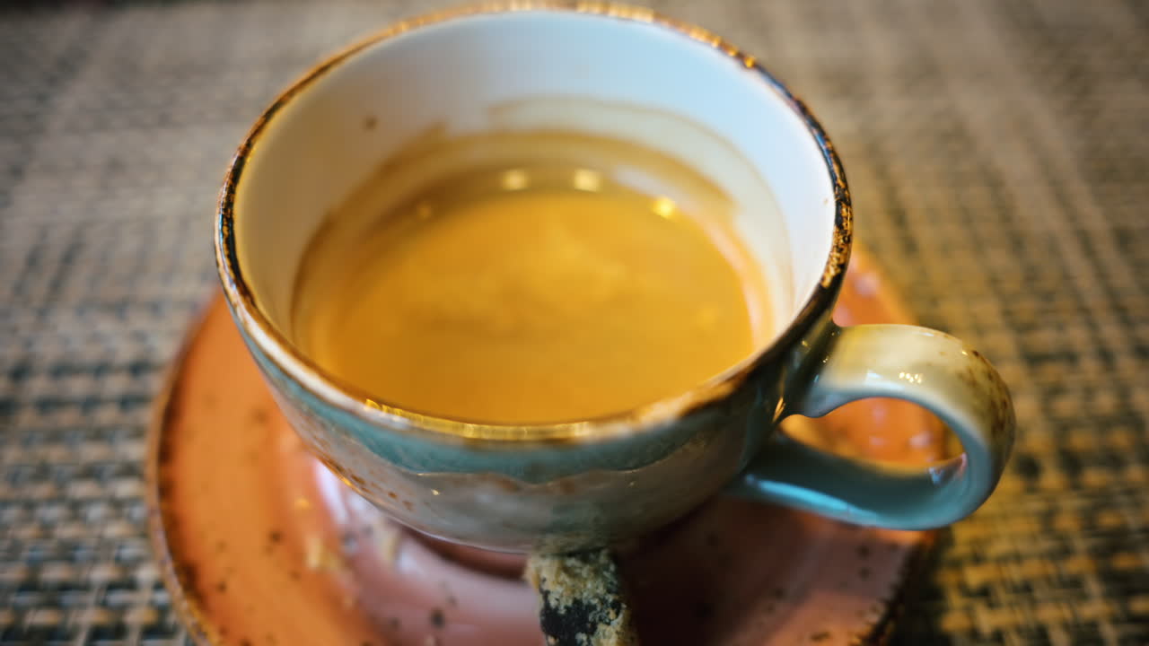 Cup of coffee in a ceramic mug in a rustic environment