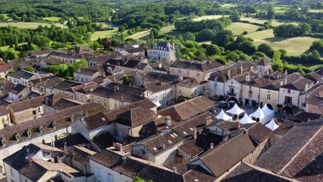 Place-de-Monpazier-during-a-cultural-event,-white-stands-for-artisans-are-in-the-center-of-the-square,-Dordogne,-France