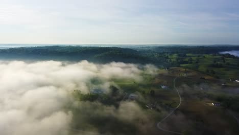 toma aérea lenta de tierras de cultivo en kentucky con capas de nubes bajas