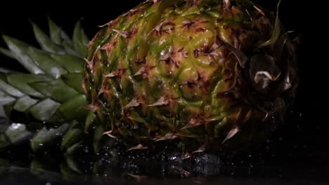 Pineapple-falling-and-splitting-on-black-background