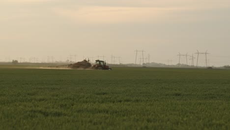 tractor spraying wheat crops against fungal plant disease