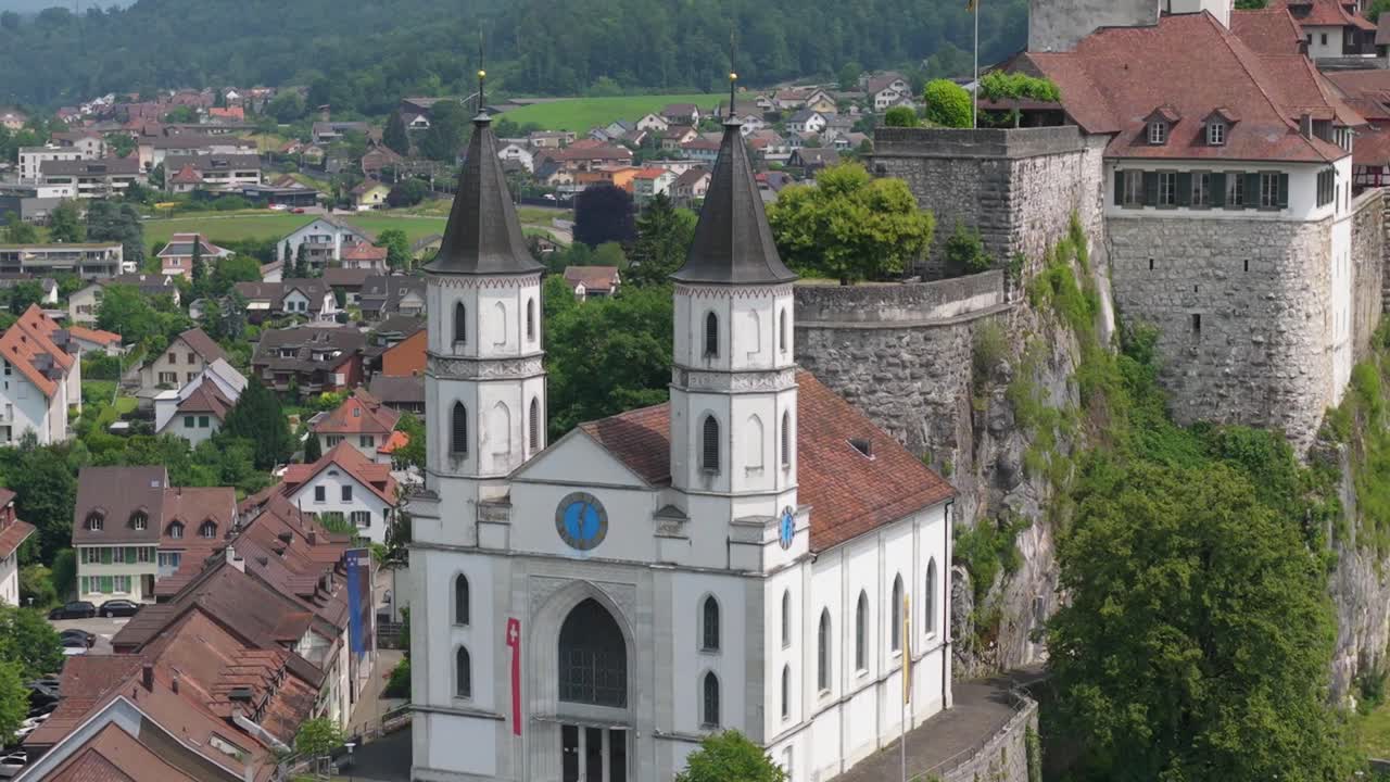 Frontal view of church and fortress architecture on elevated terrain above Aarburg