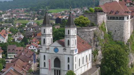 frontal view of church and fortress architecture on elevated terrain above aarburg