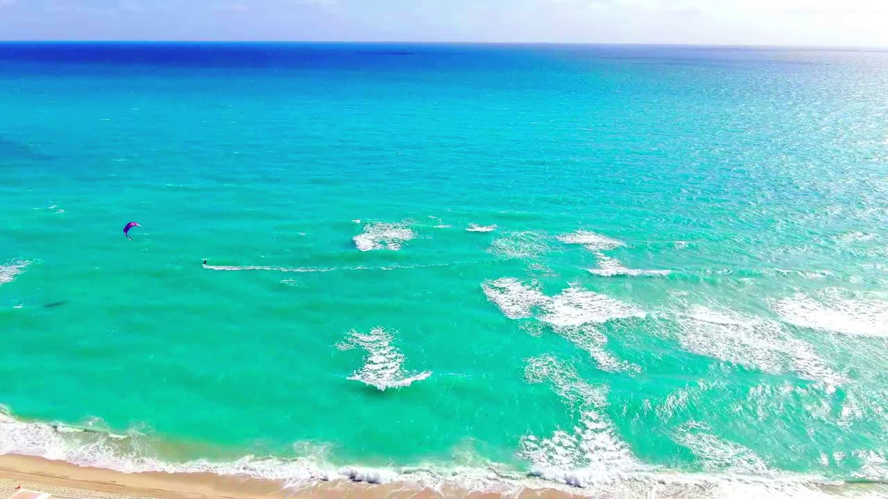 Aerial view of a kitesurfer carving waves off Miami Beach