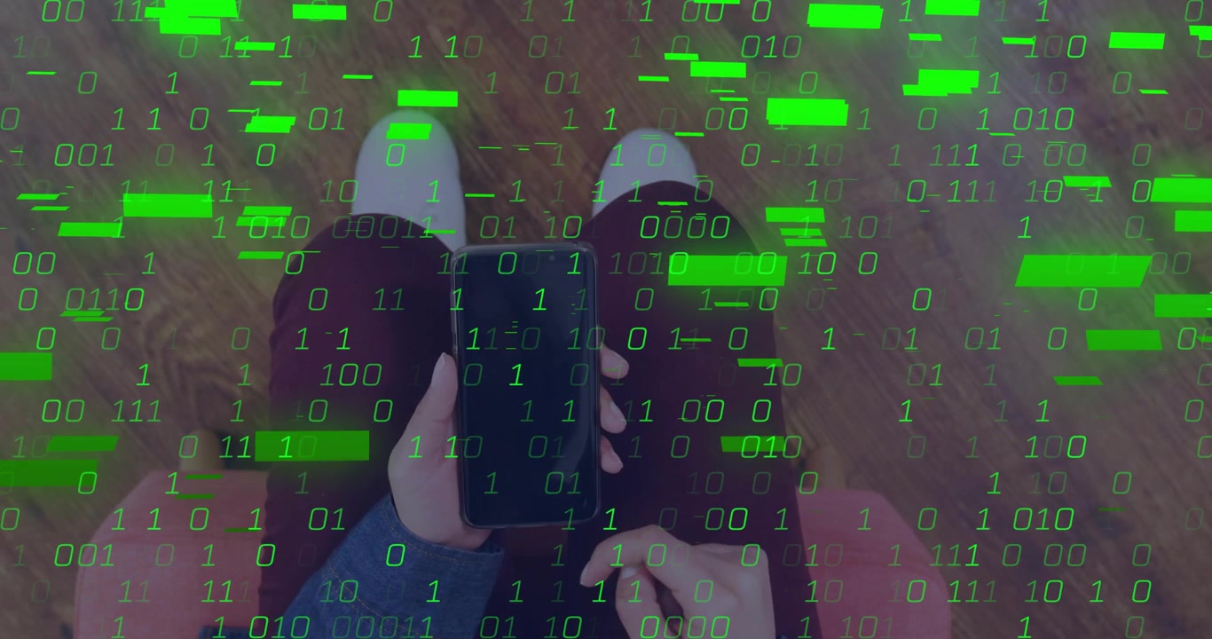 Vertical video: Adult female in denim sitting in pink chair tapping phone causing green binary grid