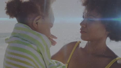 animation of light trails over african american woman and her daughter embracing at beach