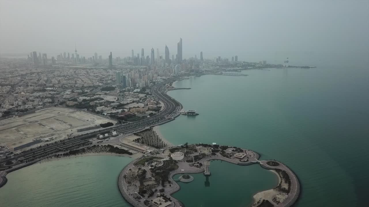 Kuwait City waterfront (Arabian Gulf). Skyline panoramic view, overcast weather. Slow forward Dolly Shot