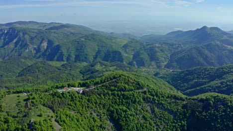 aerial panoramic shot of green mountain range of rhodope mountains and holy krastova gora