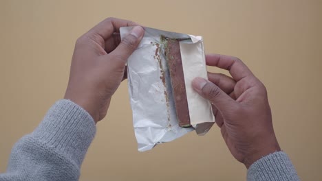 person opening a mint chocolate bar