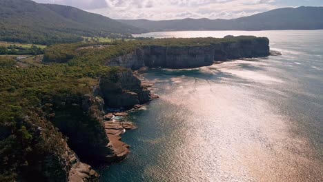 forward drone shot of tasman national park during sunny day in australia