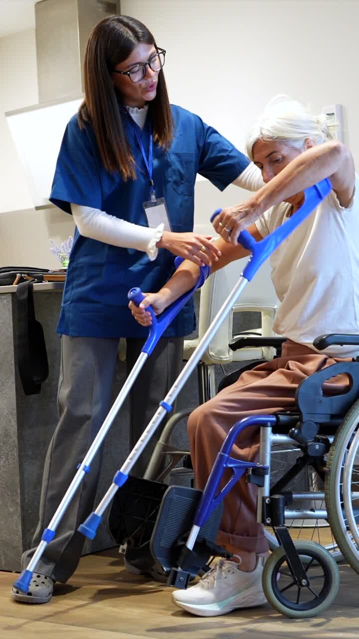 Caregiver Assisting Senior Woman with Crutches
