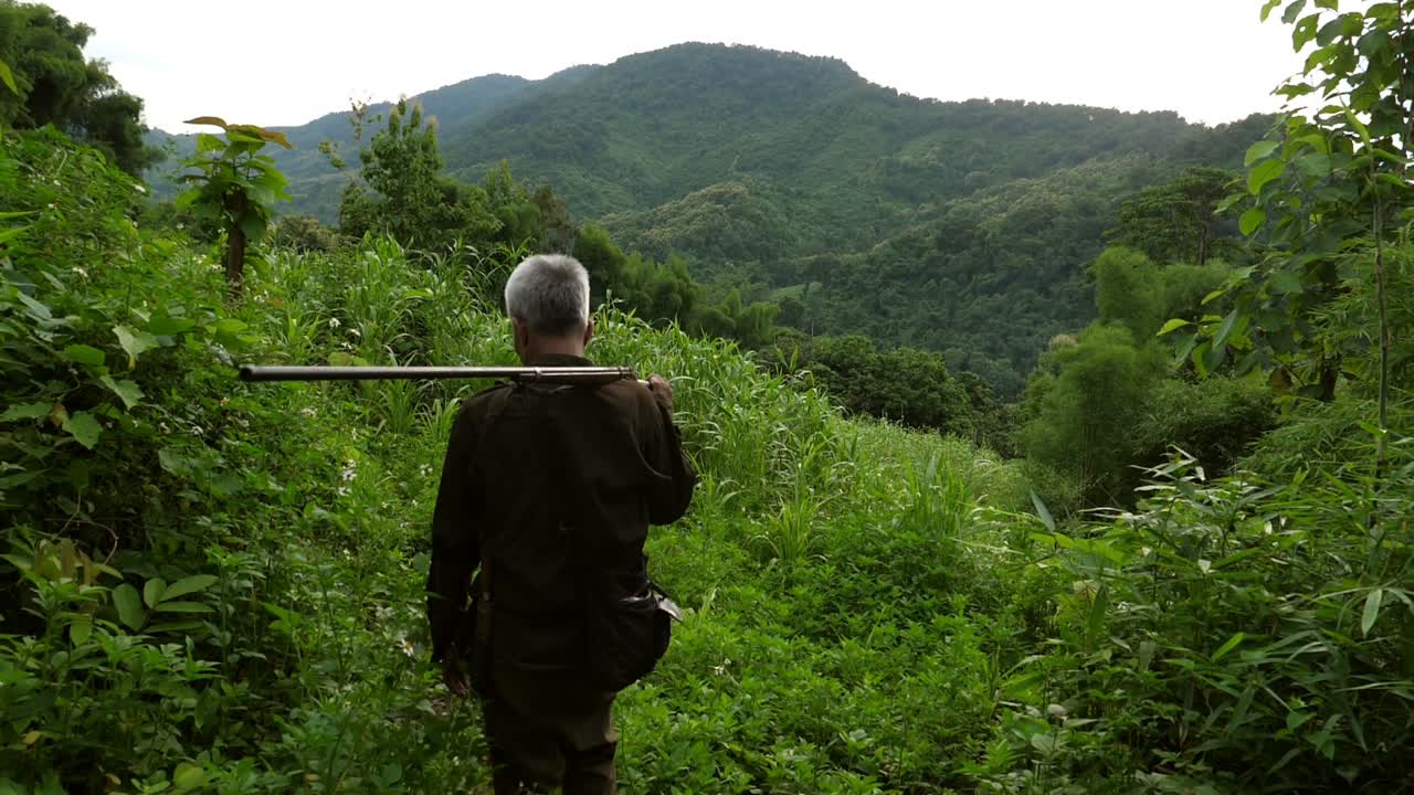 Asian Senior Hunter On The Mountain