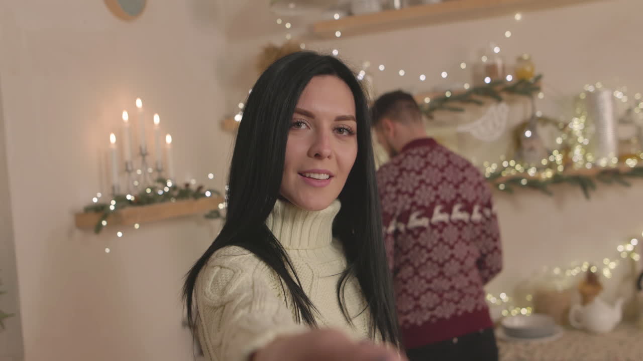 beautiful woman taking a selfie video with her boyfriend on christmas at  home