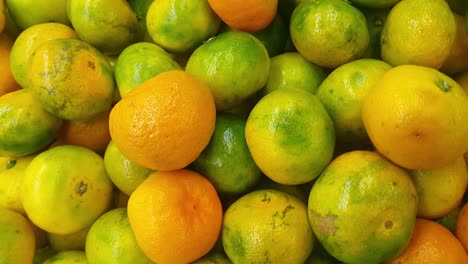 closeup view of big fresh oranges placed on a floor. a close up view of fresh oranges