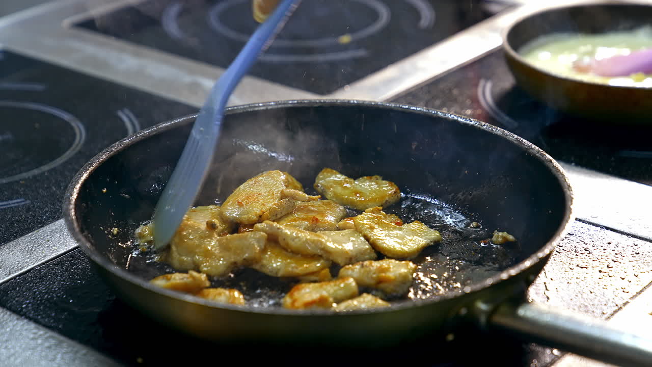 Close up of frying in pan. Chef cooking food in large pan at restaurant
