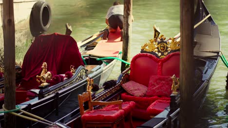 a man is cleaning his gondola boat on a canal in venice, italy