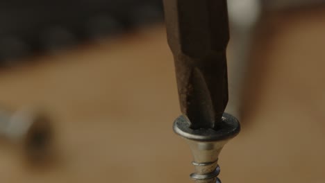 macro view of electric screw driver drill bit drilling screw in slow motion